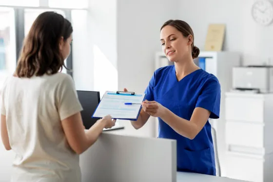 A member of the care team welcoming a patient